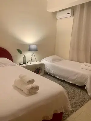 a hotel room with two beds with towels on them at Stylish Well-Equipped 2-bed flat in Nicosia Centre in Strovolos