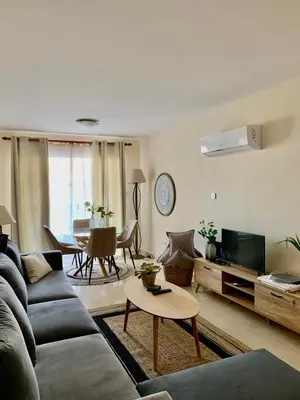a living room with a couch and a table at Stylish Well-Equipped 2-bed flat in Nicosia Centre in Strovolos