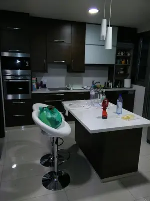 a kitchen with a counter and a stool in a kitchen at Modern spotless house with full privacy and WiFi in Aglantzia Nicosia in Aglantzia