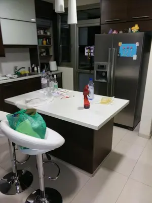 a kitchen with a white counter and a refrigerator at Modern spotless house with full privacy and WiFi in Aglantzia Nicosia in Aglantzia