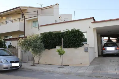 a house with two cars parked in front of it at Modern spotless house with full privacy and WiFi in Aglantzia Nicosia in Aglantzia