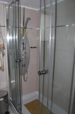 a shower with a glass door in a bathroom at Modern spotless house with full privacy and WiFi in Aglantzia Nicosia in Aglantzia