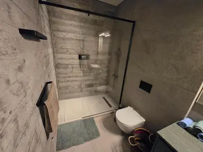 a bathroom with a shower and a toilet at Green Leaf - Old City Suite in Limassol