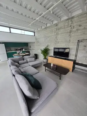 a living room with a large couch and a piano at Green Leaf - Old City Suite in Limassol