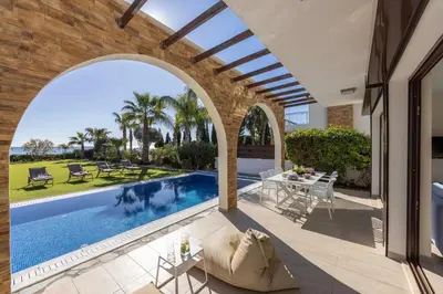 an archway over a swimming pool in a house at Ayia Napa Seafront Ionion Villa H5 in Ayia Napa