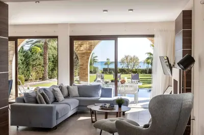 a living room with a couch and a table at Ayia Napa Seafront Ionion Villa H5 in Ayia Napa