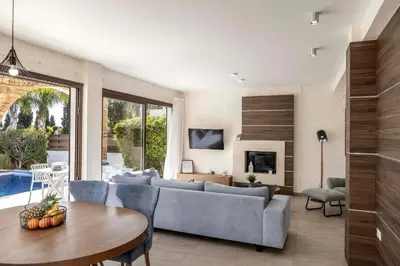 a living room with a couch and a table at Ayia Napa Seafront Ionion Villa H5 in Ayia Napa