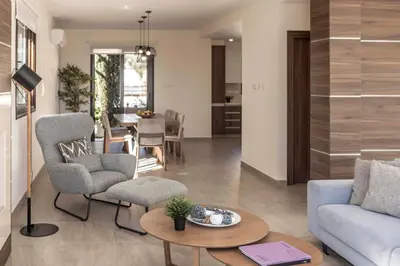 a living room with a couch and a table at Ayia Napa Seafront Ionion Villa H5 in Ayia Napa