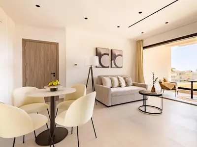 a living room with a couch and a table and chairs at Sanders Eduardovich Limassol in Limassol