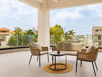 a patio with a couch and chairs and a table at Sanders Eduardovich Limassol in Limassol
