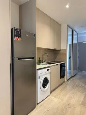 a kitchen with a refrigerator and a washing machine at Aurora Downtown Living in Nicosia
