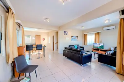 a living room with a couch and a table at Villa Maria in Protaras