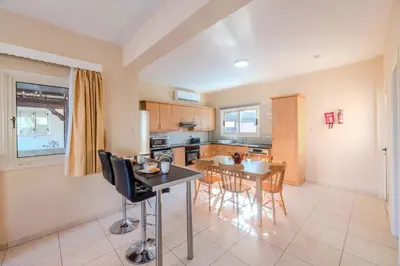 a kitchen and dining room with a table and chairs at Villa Maria in Protaras