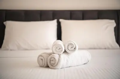 a pile of towels sitting on top of a bed at Jupiter Villa in Voroklini