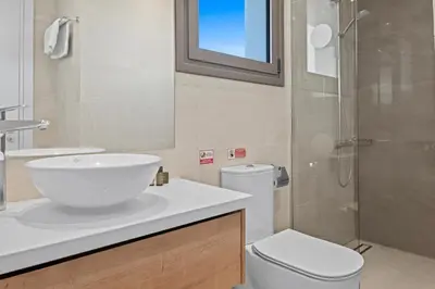 a bathroom with a sink and a toilet and a shower at Serenity Waves Villa 2 in Larnaka