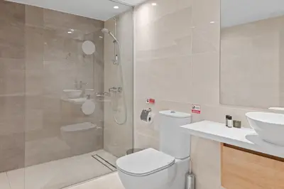 a bathroom with a shower and a toilet and a sink at Serenity Waves Villa 2 in Larnaka