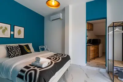 a bedroom with blue walls and a bed at The Pop Art Residences & Studios in Larnaca in Larnaka