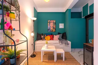 a living room with blue walls and a couch at The Pop Art Residences & Studios in Larnaca in Larnaka