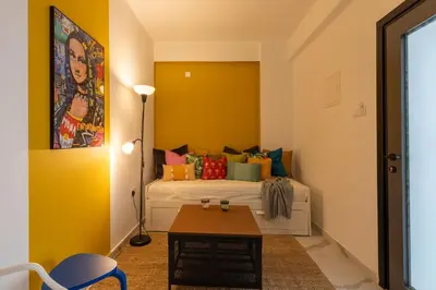 a bedroom with a bed with colorful pillows at The Pop Art Residences & Studios in Larnaca in Larnaka