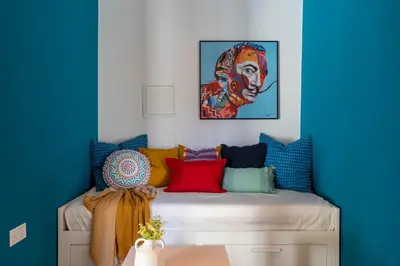 a room with a bed with colorful pillows at The Pop Art Residences & Studios in Larnaca in Larnaka