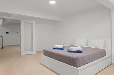a white bedroom with a bed with towels on it at Serenity Waves Villa 5 in Larnaka