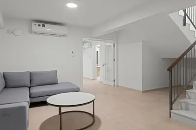 a living room with a couch and a table at Serenity Waves Villa 5 in Larnaka