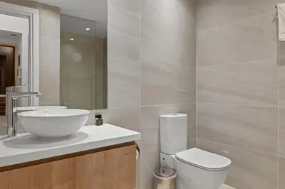 a bathroom with a sink and a toilet and a mirror at Serenity Waves Villa 5 in Larnaka
