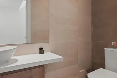 a bathroom with a sink and a mirror and a toilet at Serenity Waves Villa 5 in Larnaka