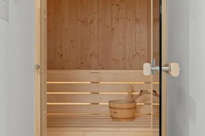 a sauna with a wooden tub and a bucket at Serenity Waves Villa 5 in Larnaka