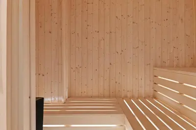 a sauna with wooden walls and a wooden bench at Serenity Waves Villa 5 in Larnaka