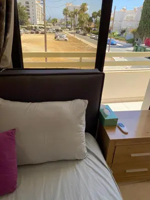 a bedroom with a bed with a view of a street at A sea breeze house in Voroklini