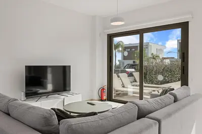 a living room with a couch and a tv at Serenity Waves Villa 11 in Larnaka
