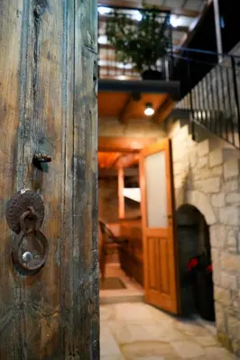 a wooden door with a knob in a hallway at Vouni Calais in Vouni