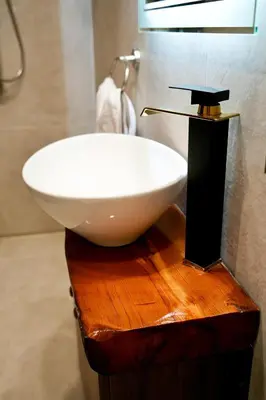 a white sink on a wooden table in a bathroom at Vouni Calais in Vouni