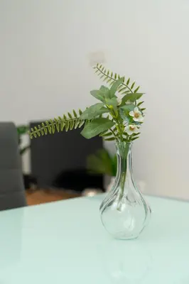 a glass vase with flowers in it on a table at 1 bedroom flat in Aglatzia in Aglantzia