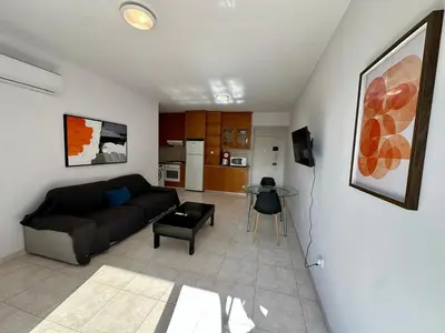 a living room with a couch and a table at 1 bedroom flat 200m from beach in Limassol