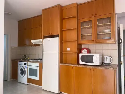a kitchen with a white refrigerator and a microwave at 1 bedroom flat 200m from beach in Limassol