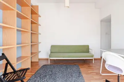 a living room with a green couch and a chair at Central Escape in Limassol