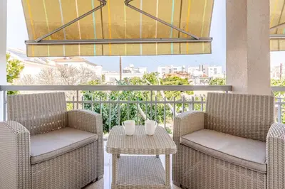two chairs and a table on a balcony with a view at Central Escape in Limassol