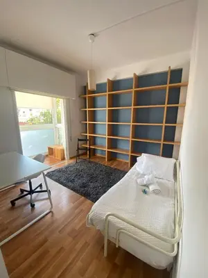 a room with a bed and a desk and a table at Central Escape in Limassol