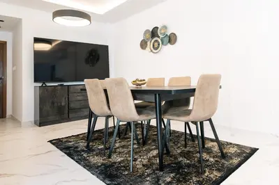 a dining room with a black table and chairs at Kozakos Residence in Limassol