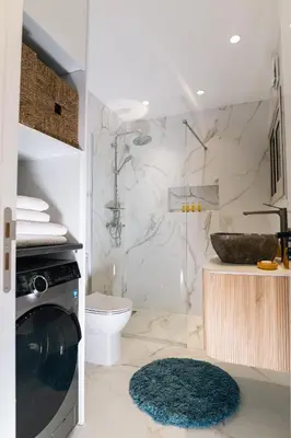 a bathroom with a toilet and a sink and a washing machine at Kozakos Residence in Limassol