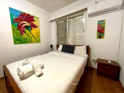 a bedroom with a bed and a painting on the wall at Comfort Stay in Nicosia - Aglantzia RIK in Nicosia