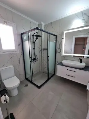 a bathroom with a shower and a toilet and a mirror at North Cyprus Thalassa beach resort in Paralimni