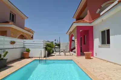 a swimming pool in the backyard of a house at Wealthystays 3BR Terrace BBQ Villa with pool in Liopetri