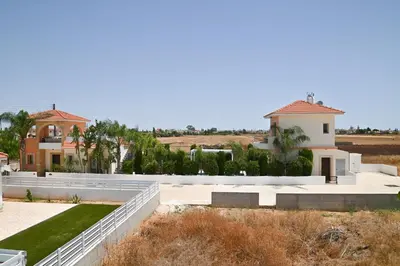 an aerial view of a house with a yard at Wealthystays 3BR Terrace BBQ Villa with pool in Liopetri