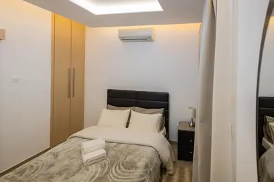 a bedroom with a bed with white sheets at Lap of luxury in Limassol