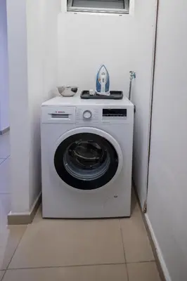 a white washing machine sitting in a room at Lap of luxury in Limassol