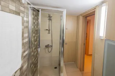a shower with a glass door in a bathroom at Lap of luxury in Limassol