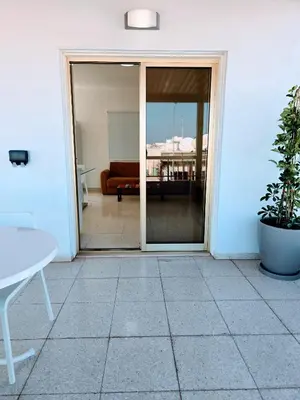 an open door to a patio with a couch at Greco 356 Apartment in Protaras